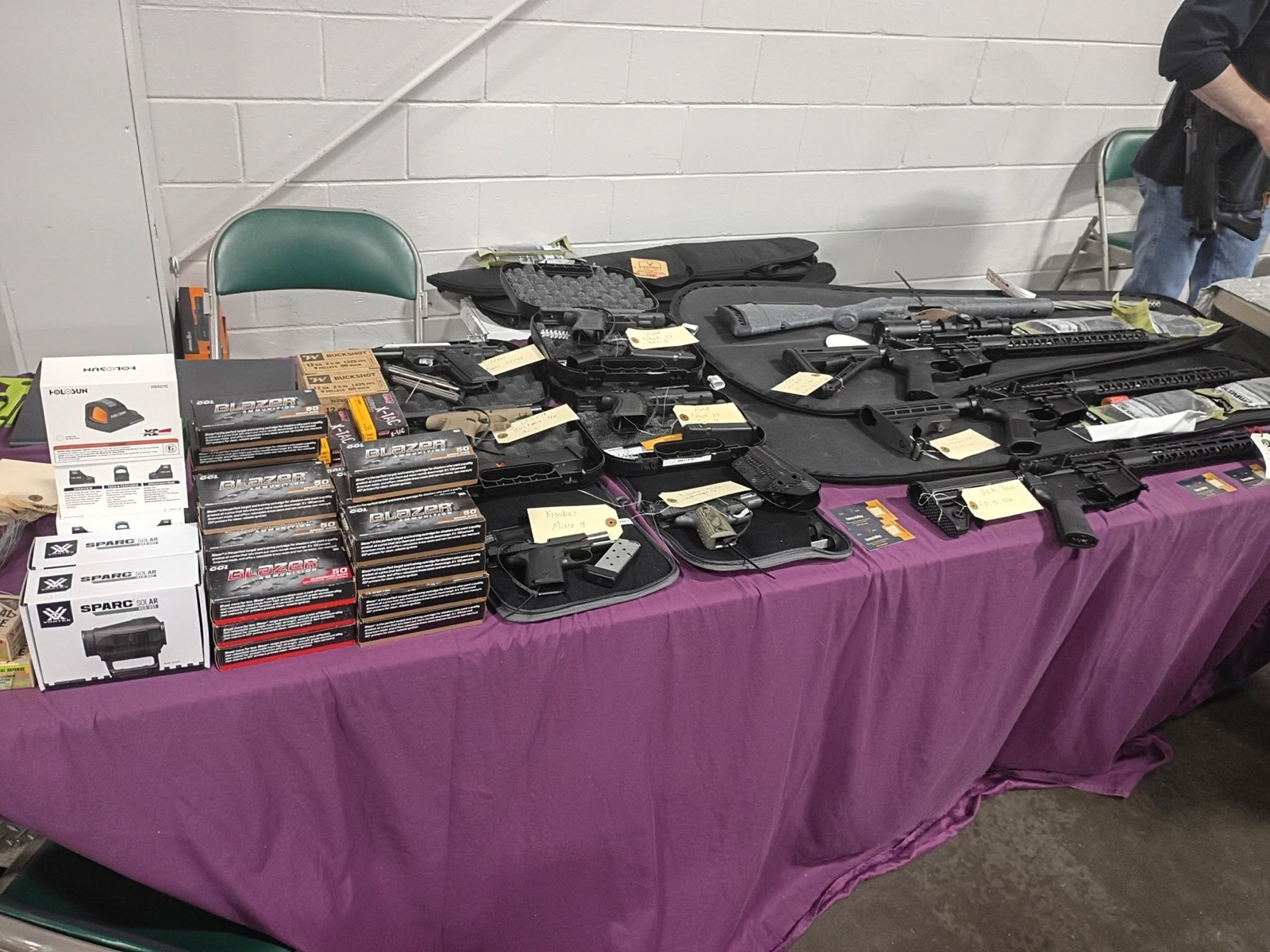 Gun show table with firearms ammunition and optics from Phoenix Freedom Firearms