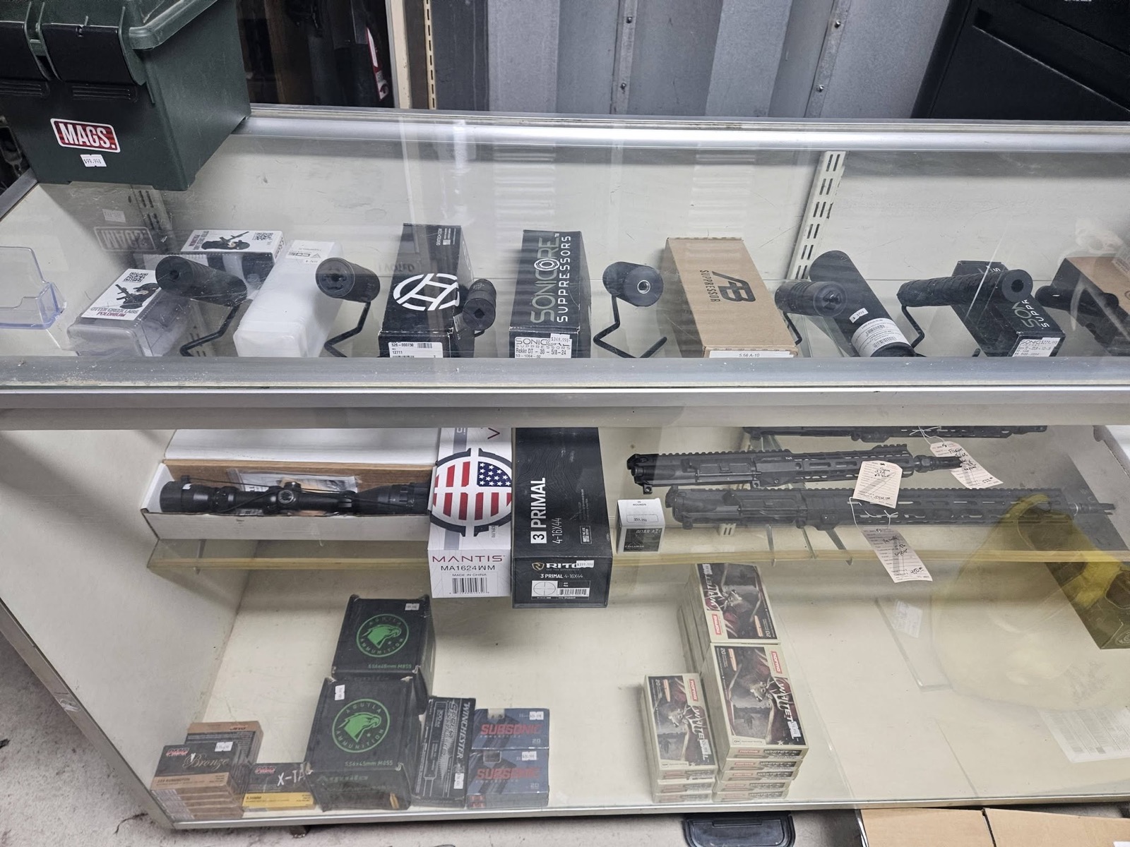 Suppressors optics and ammunition in local display case