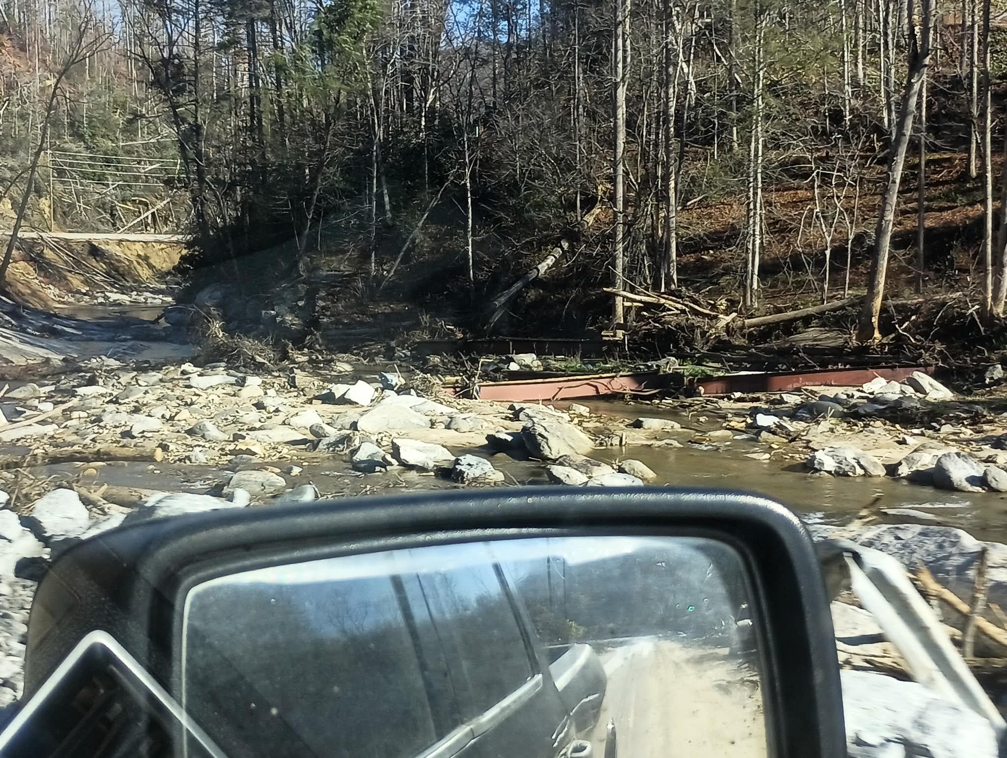 Creek crossing and damaged bridge area during disaster relief support