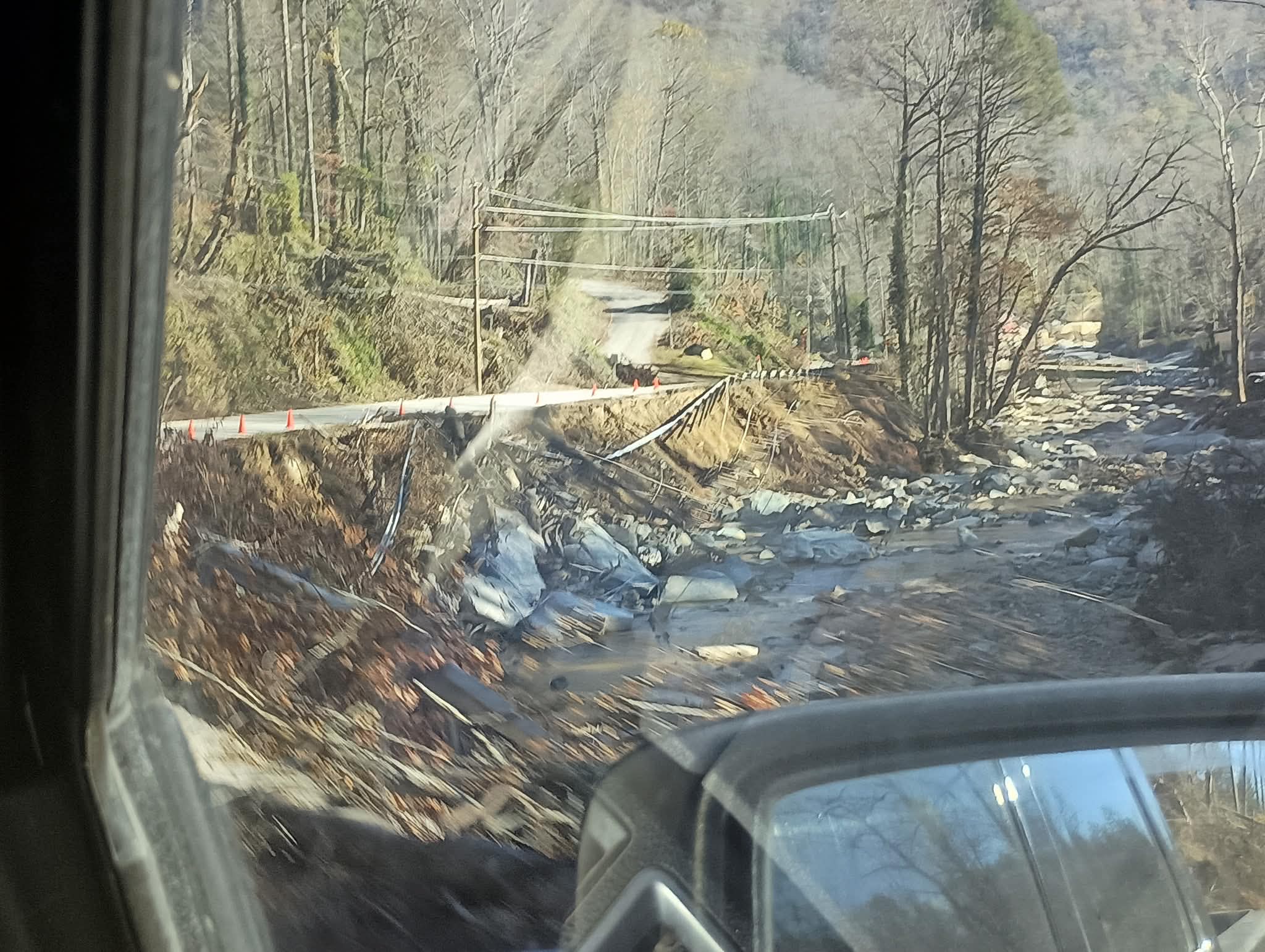 Flood-damaged road and washed out creek crossing during disaster relief support